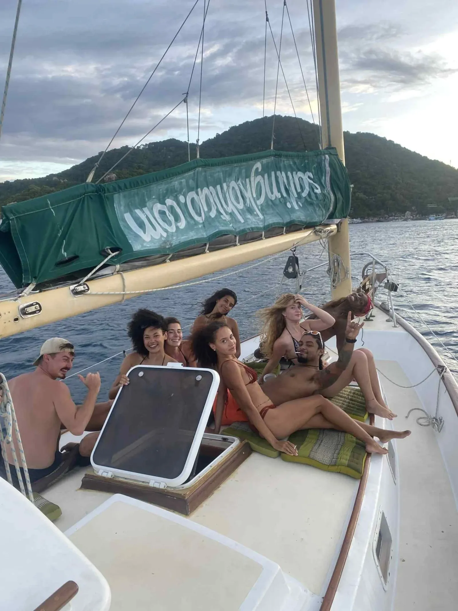 A group of friends relaxing together on a private charter near Koh Tao