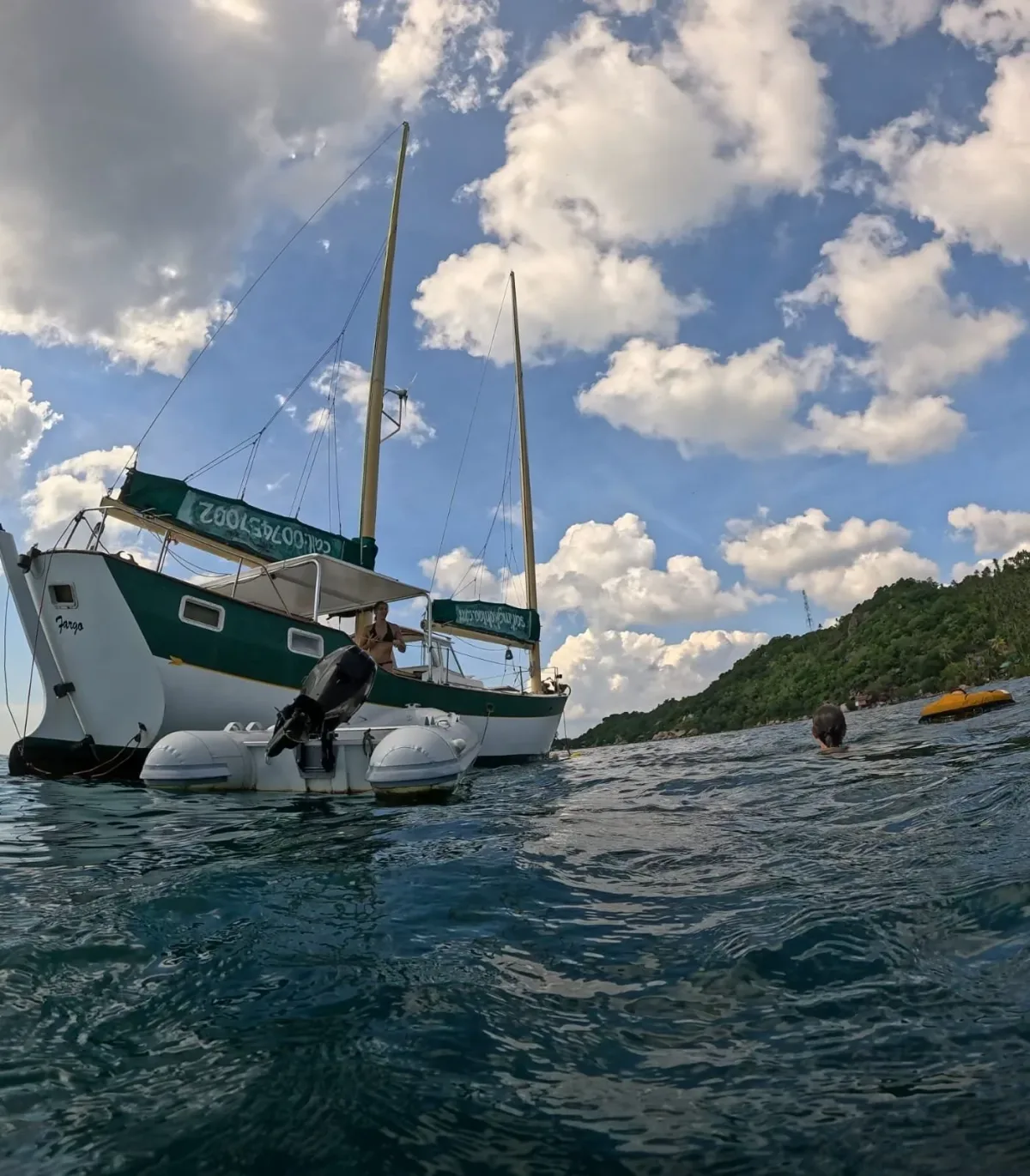SV Freedom Fargo working at a dive site under a dramatic Gulf of Thailand sky