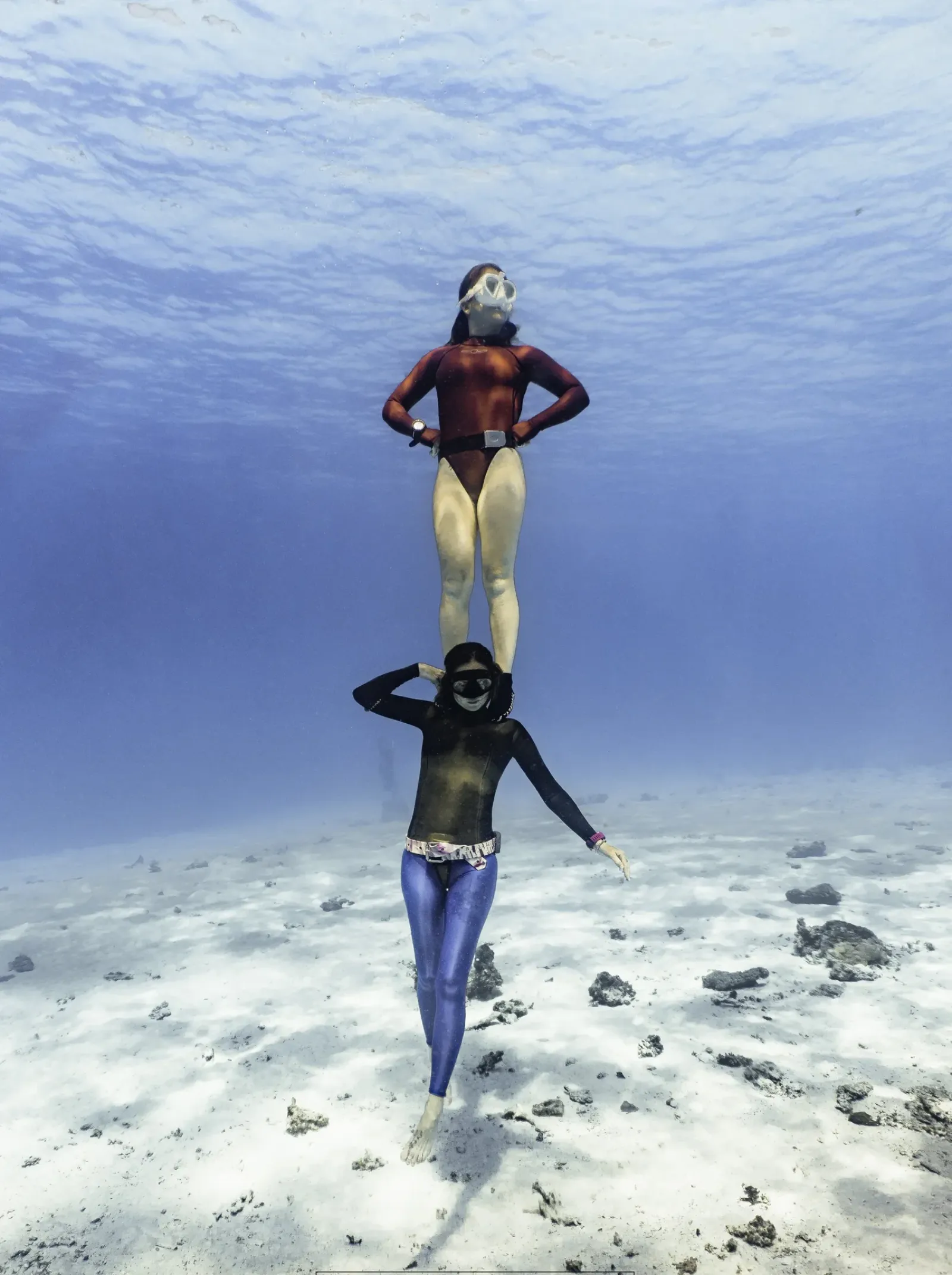 Two freedivers training together underwater near Koh Tao